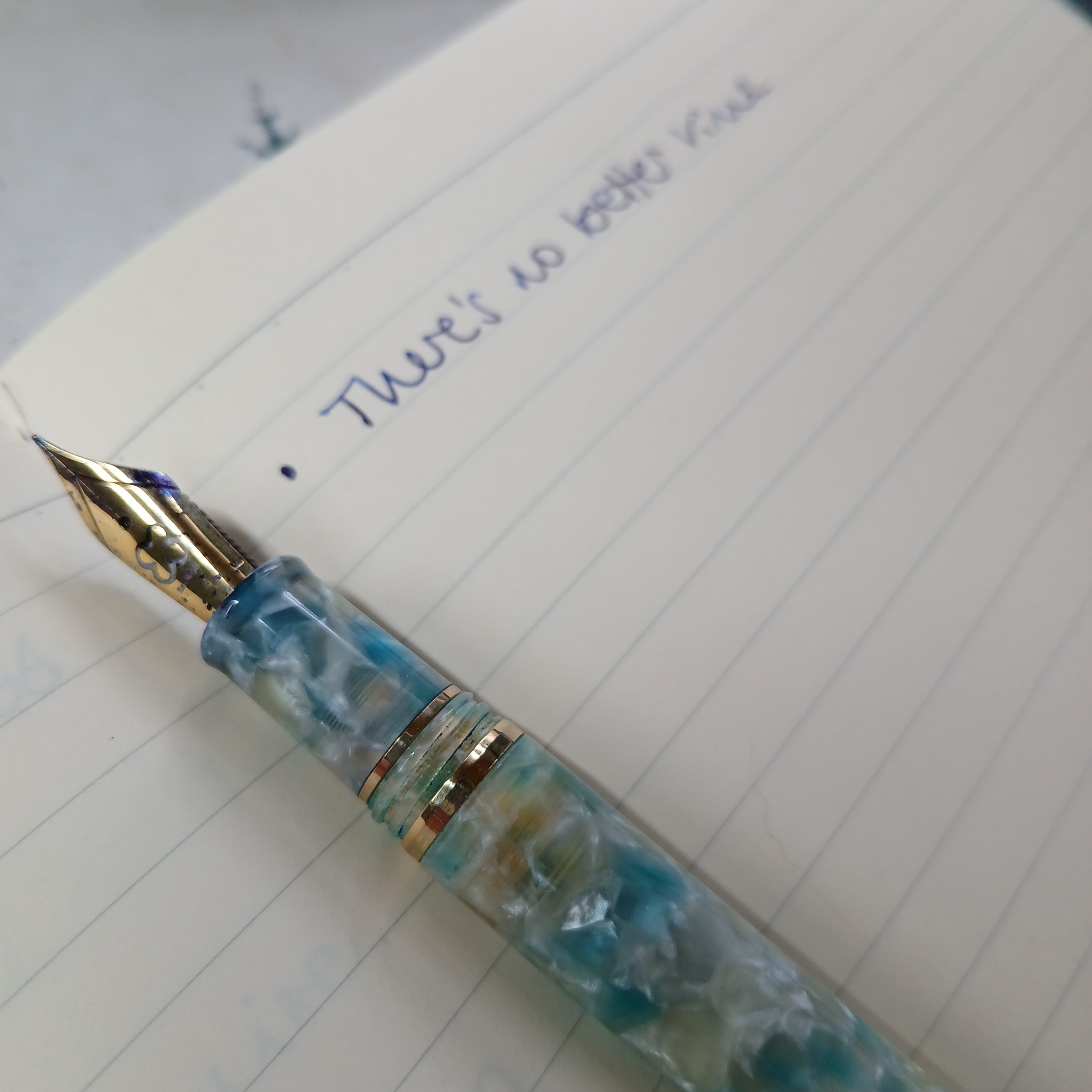 A fountain pen lies on a notebook, where the words are written 'There's no better time'